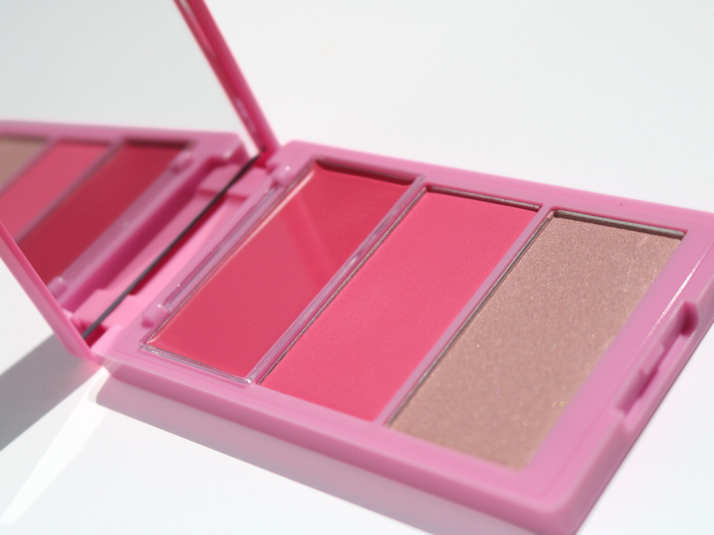 Cheek palette with pink and champagne shades on a white background