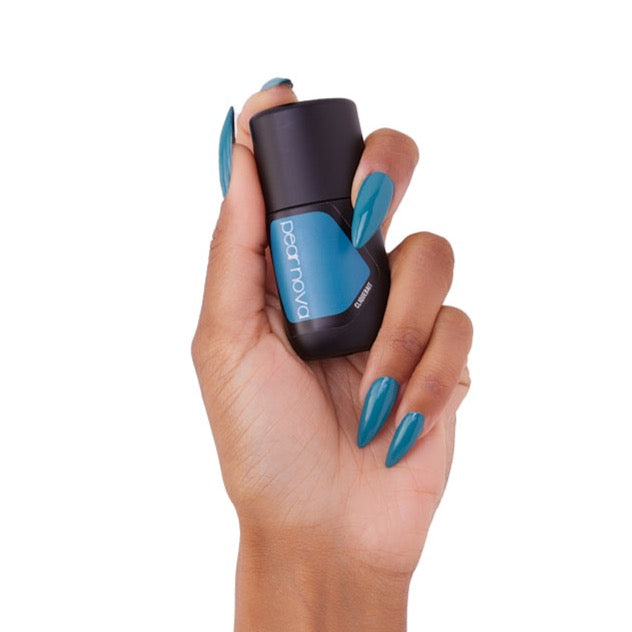 brown skin hand model holding bottle of nail lacquer with almond shaped painted nails turquoise