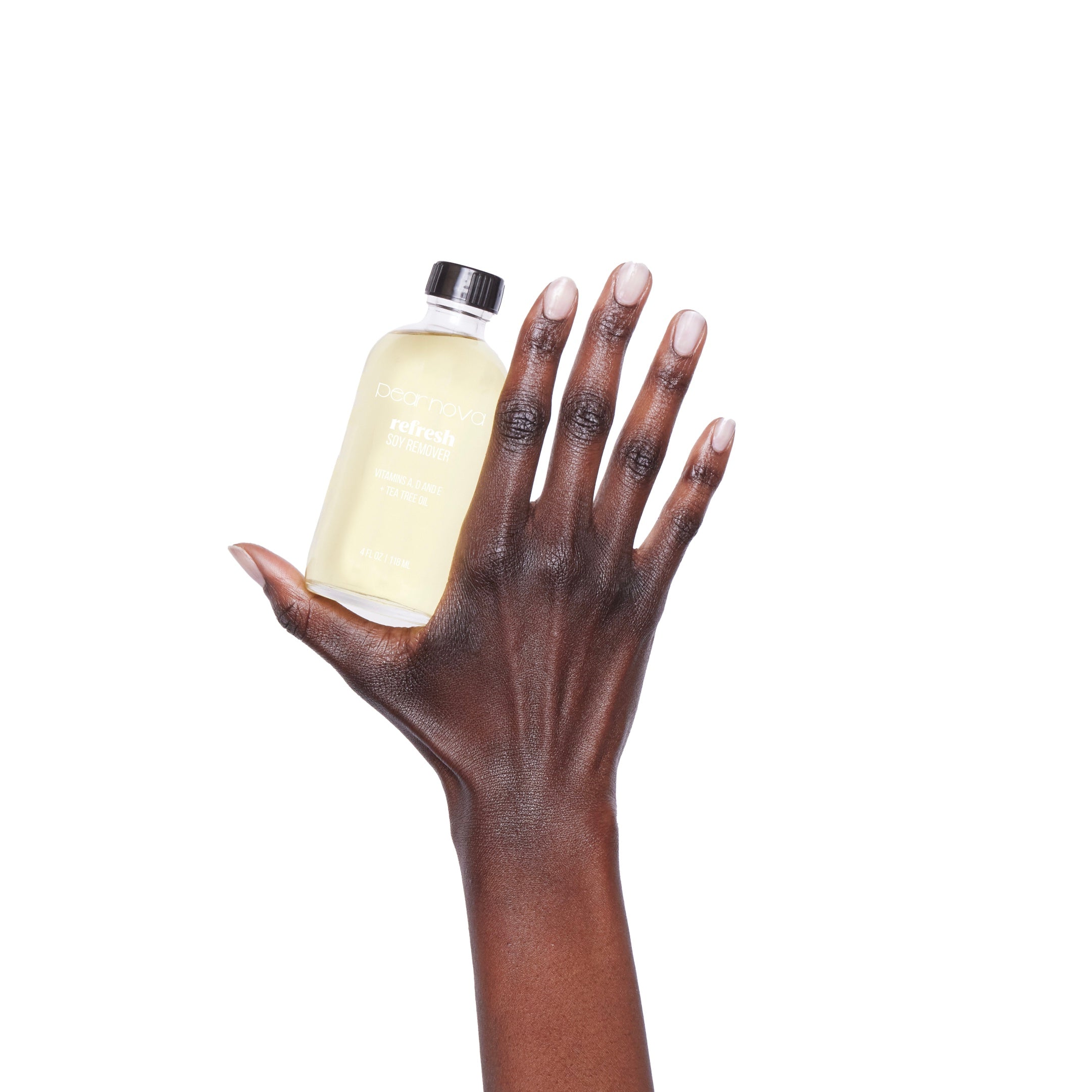 Hand model holding a bottle of Refresh Soy Nail Polish Remover