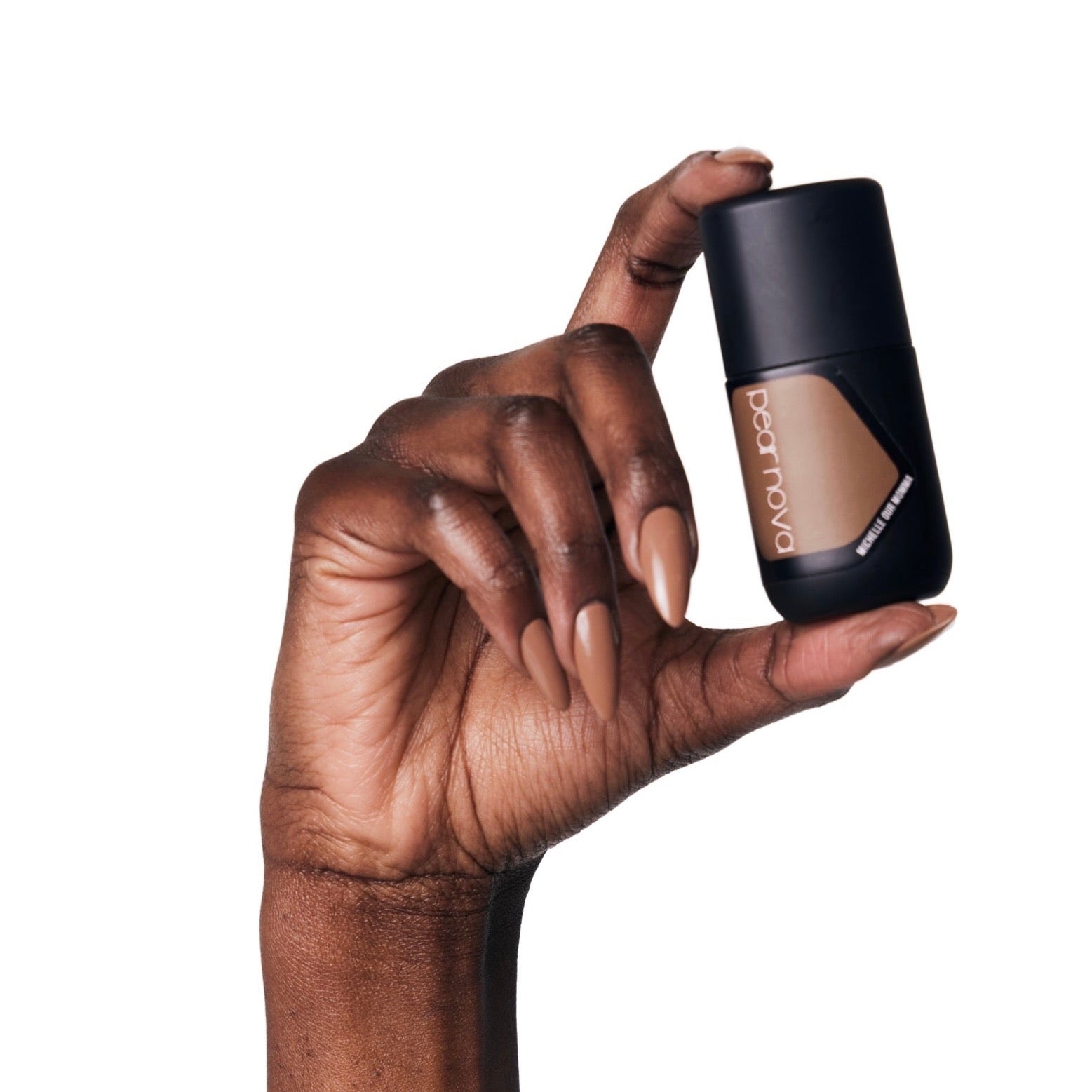 brown skin hand model holding bottle of nail lacquer with Michelle Our Mama almond shaped painted nails