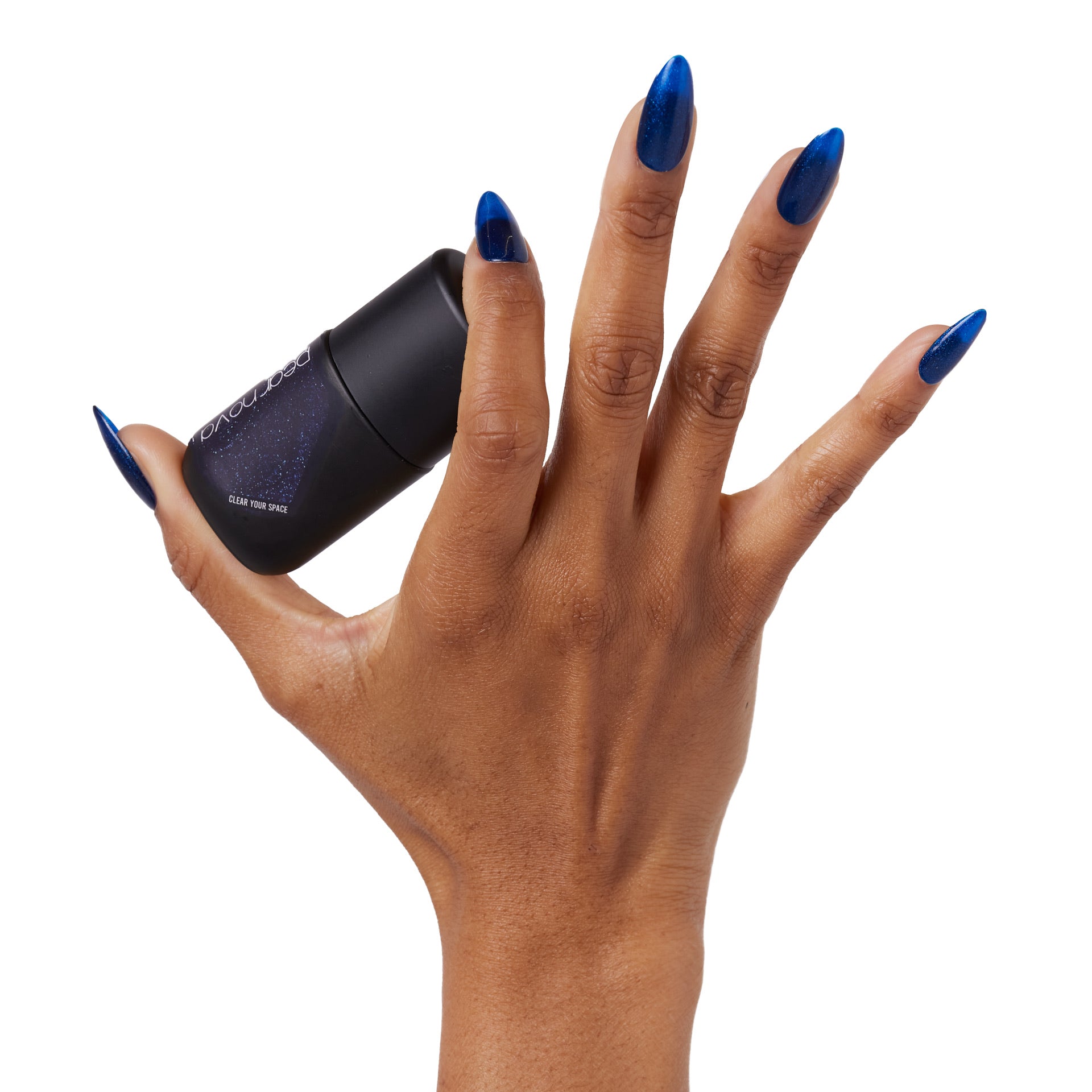 brown skin hand model holding bottle of nail lacquer with almond shaped painted nails