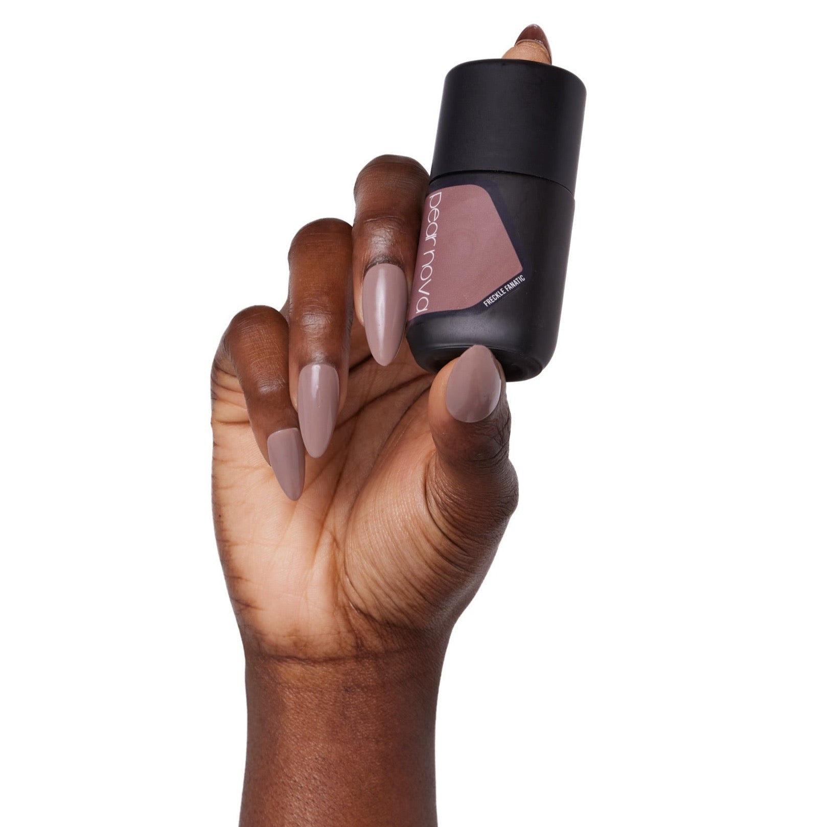 brown skin hand model holding bottle of nail lacquer with almond shaped painted nails 