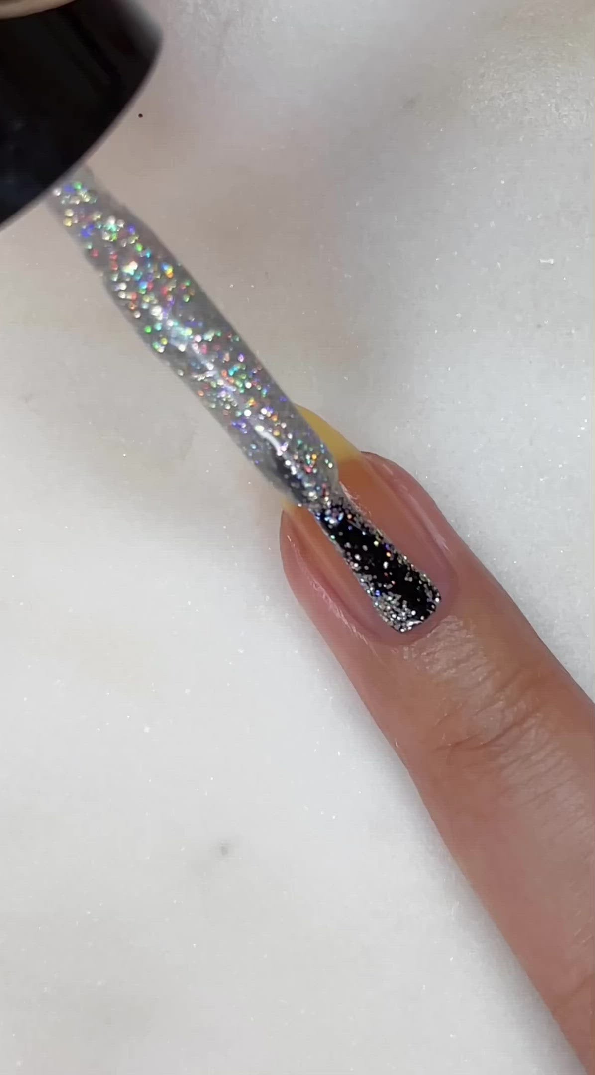 video of fair skin hand model painting nails with nail lacquer showing smooth application and finished product