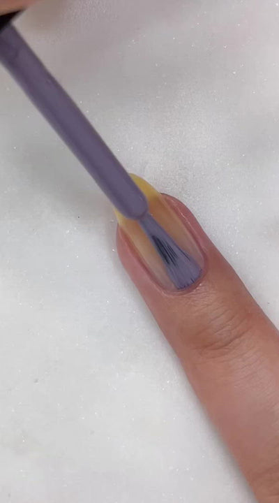 video of fair skin hand model painting nails with nail lacquer showing smooth application and finished product