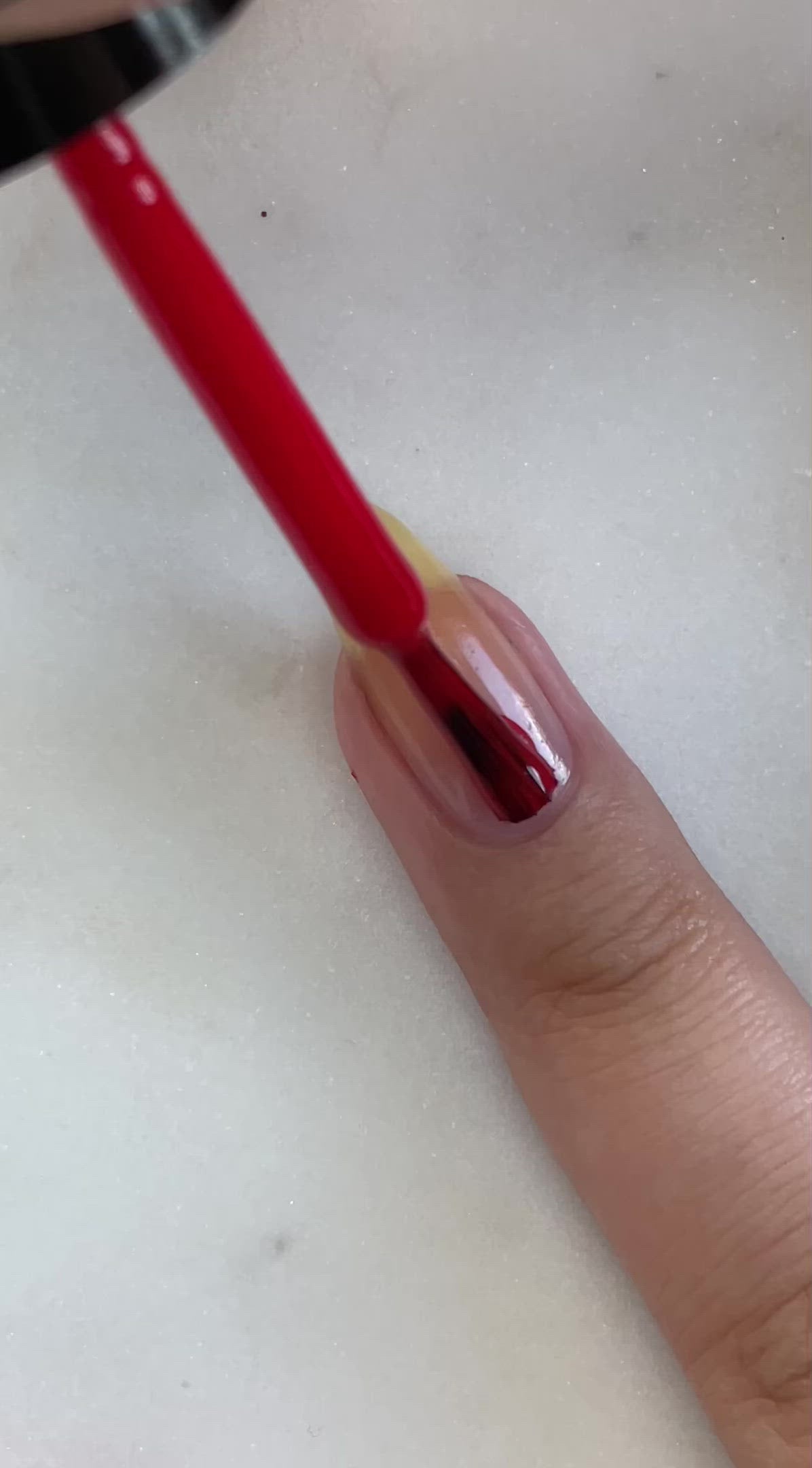 video of fair skin hand model painting nails with nail lacquer showing smooth application and finished product