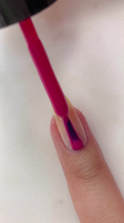 video of fair skin hand model painting nails with nail lacquer showing smooth application and finished product