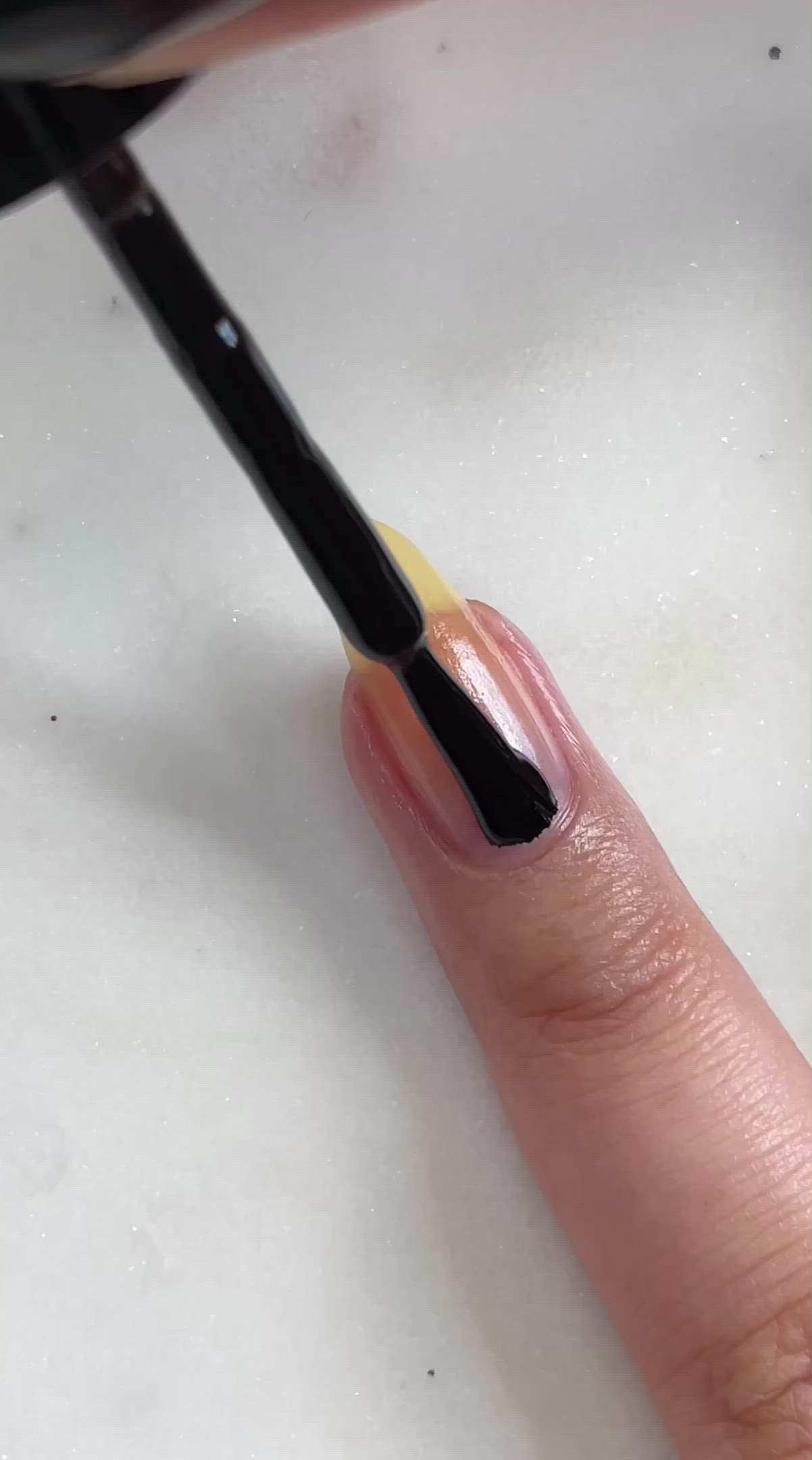 video of natural nails being painted black