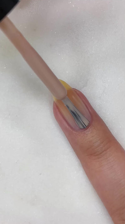 video of fair skin hand model painting nails with Dianna Boss nail lacquer showing smooth application
