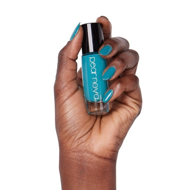 brown skin hand model holding bottle of nail lacquer with almond shaped turquoise painted nails in Cliquebait 