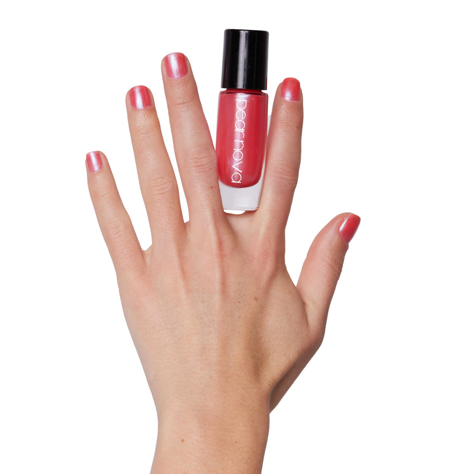 fair skin hand model holding bottle of nail lacquer with short natural painted nails 