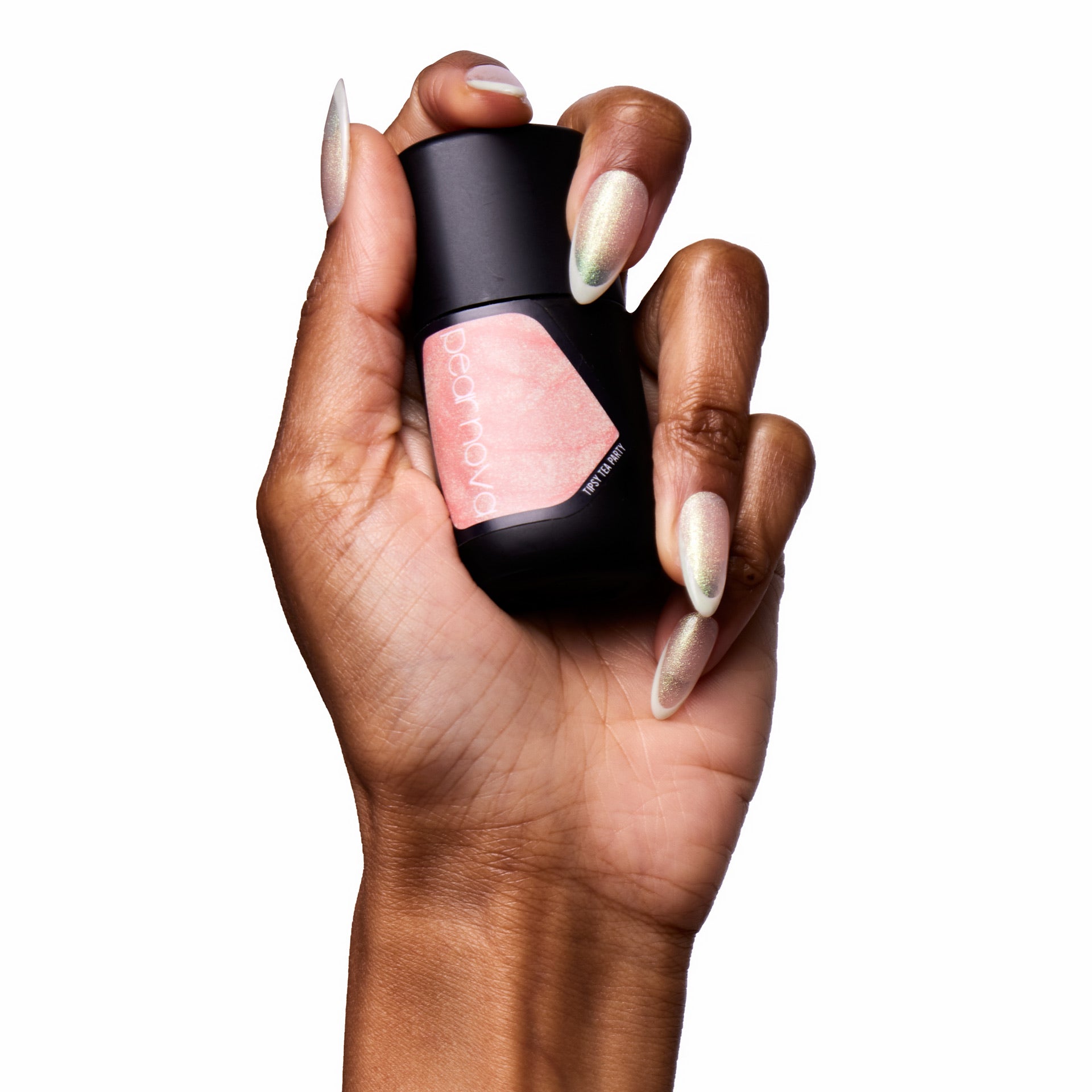brown skin hand model holding bottle of nail lacquer with almond shaped painted nails 