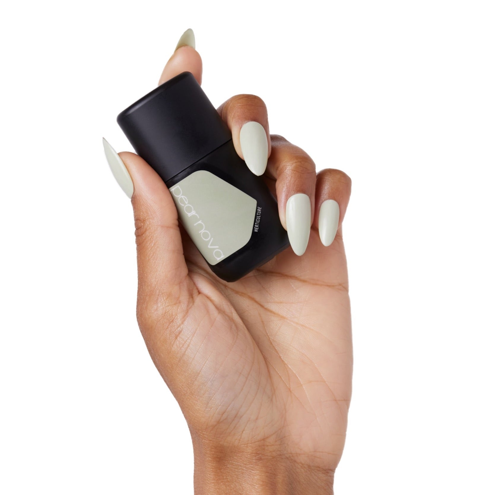 brown skin hand model holding bottle of nail lacquer with almond shaped mint painted nails 