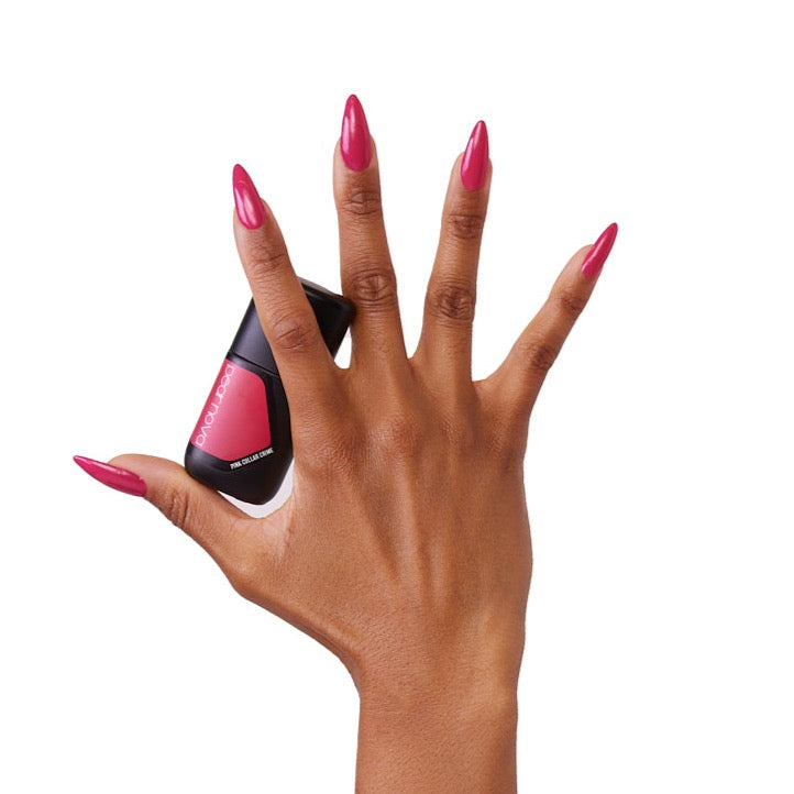 brown skin hand model holding bottle of nail lacquer with almond shaped painted nails 