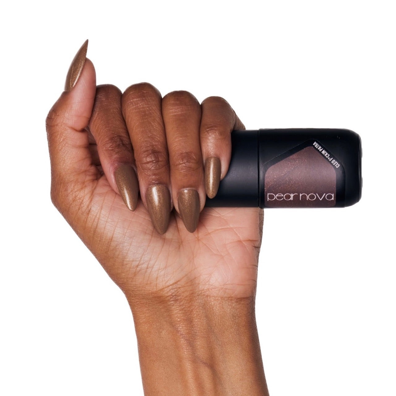 brown skin hand model holding bottle of nail lacquer with bronze almond shaped painted nails 