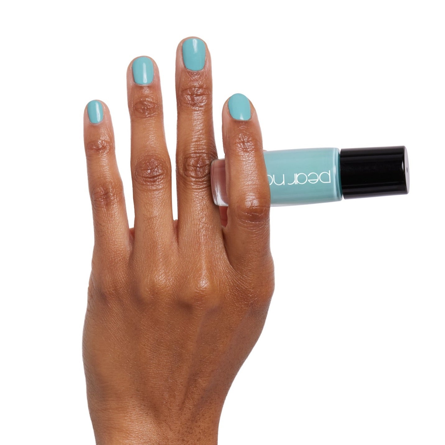 brown skin hand model holding bottle of nail lacquer with natural painted nails 